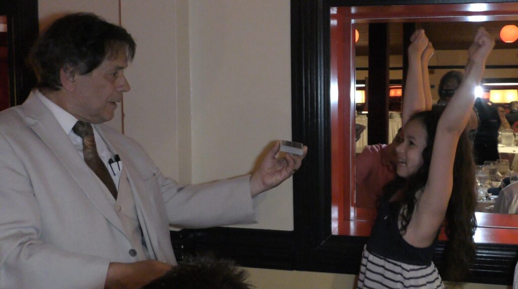 The Magic of Joe Ferranti young girl excited by Close UP Magician Joe Ferranti at Kowloon's in Saugus Massachusetts.