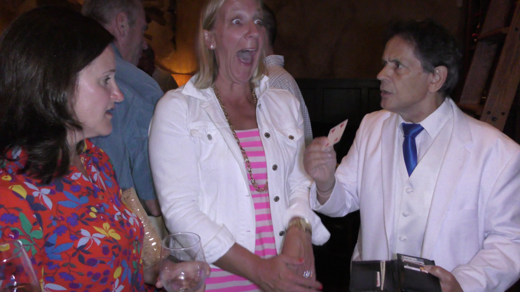 Female spectator in "shock" when Boston Magician Joe Ferranti removes a card from his wallet.