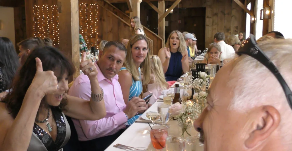 The Best in Magic Entertainment Boston Massachusetts Magician entertains spectators at a table during a wedding receotion