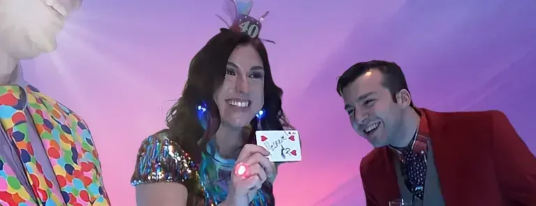 Photo of 40th Birthday party, where the Birthday girl is showing off her Magical Birthday Card with a big smile. Presented by Massachusetts Adult birthday Magician Joe Ferranti.