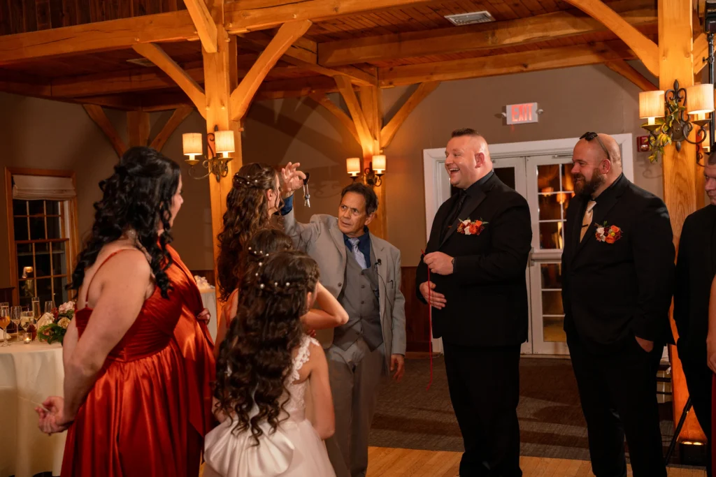 wedding cocktail hour entertainment The Best in Magic Entertainment Wedding magician Joe Ferranti performing interactive closeup magic during a lively cocktail hour in Massachusetts