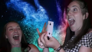 Adult guests amazed by close-up magic during a Massachusetts private party