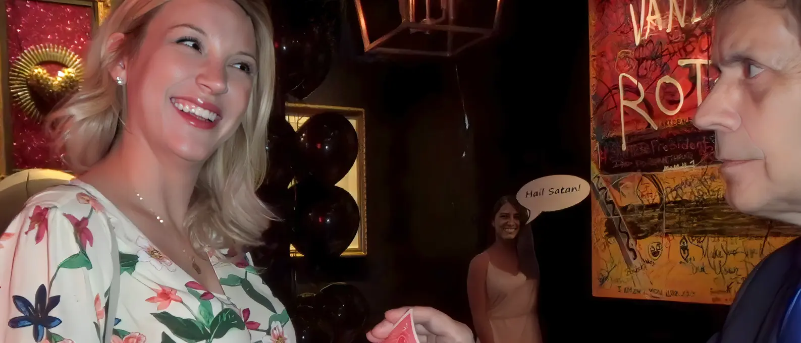 Close-up magician engaging a smiling guest during an intimate private party performance