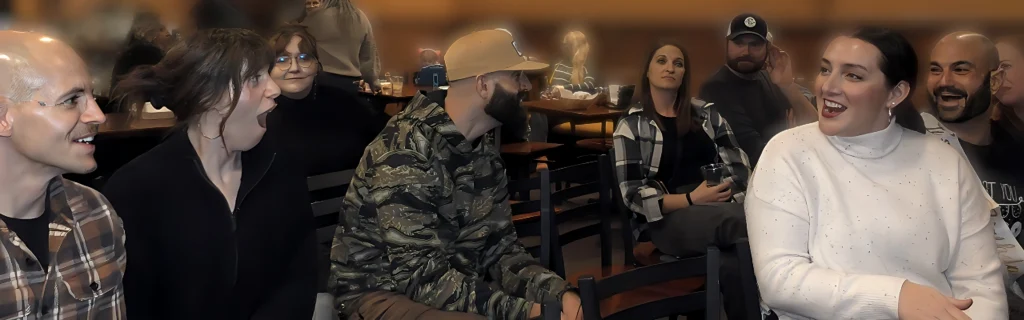 Surprised guests reacting to close-up magic during a live parlor show.