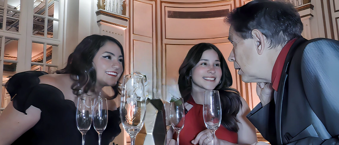 Close-up magician engaging wedding guests during a cocktail hour, creating an intimate and interactive moment.