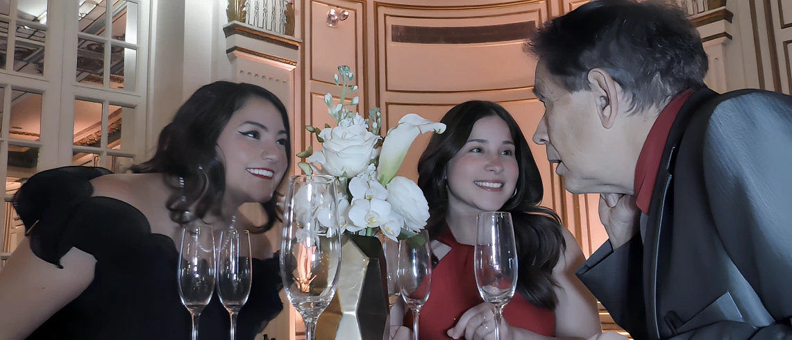Close-up magician creating strong reactions for guests at an upscale wedding cocktail hour.