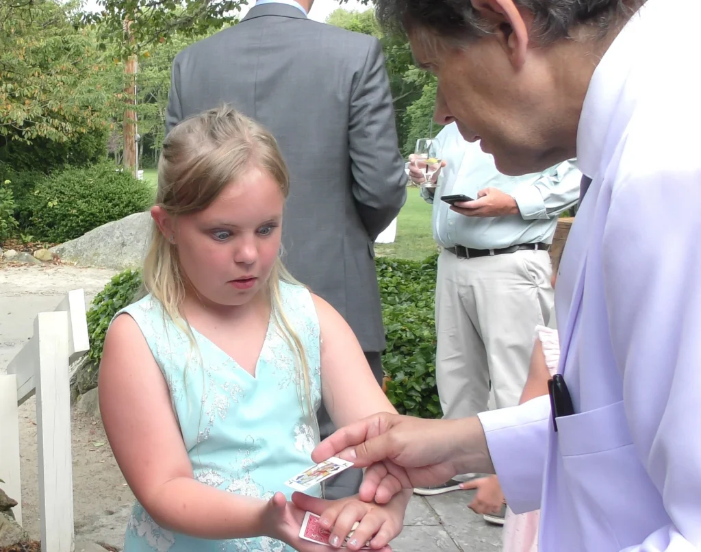 The Magic of Joe Ferranti A candid moment captures a young wedding guest's attention during a close-up magic performance. Interactive entertainment can turn even the most energetic young guests into captivated audience members, at least for a few magical minutes.